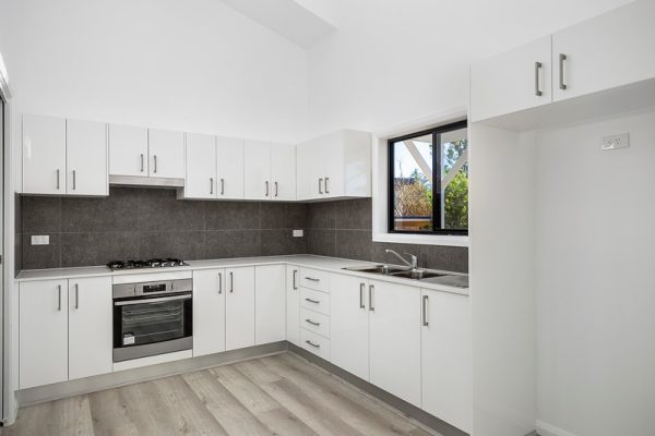 Granny-flat-Sydney-Polyurethane-kitchen-design-rakedceiling-Vinyl-flooring-tiled-splashback