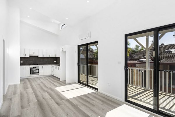 Granny-flat-sydney-open-plan-living-entertaing-patio-area-raked-ceiling-black-sliding-door