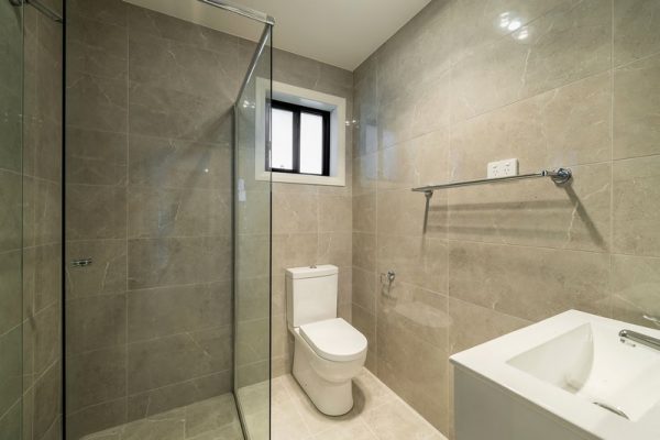 granny-flat-bluegum-bathroom-glass-shower-custom-tiles-to-ceiling-tiles-vanity-toilet
