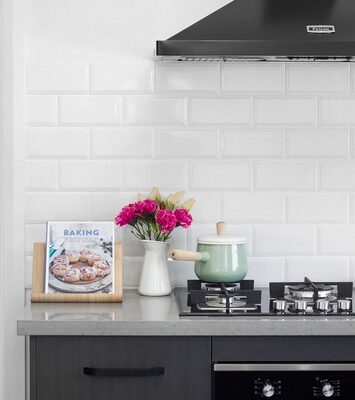 granny-flat-bluegum-sydney-detail-kitchen-black-rangehood-appliances-subway-tiles-splashback-polytec-laminate-quantum-quartz-benchtop