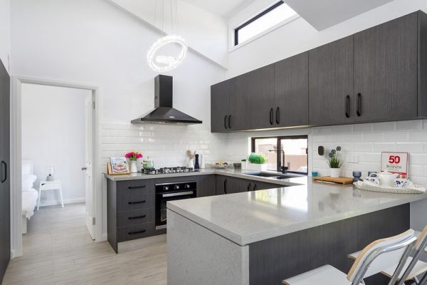 granny-flat-bluegum-sydney-u-shape-kitchen-black-appliances-polytec-laminate-quantum-quartz-benchtop-waterfall